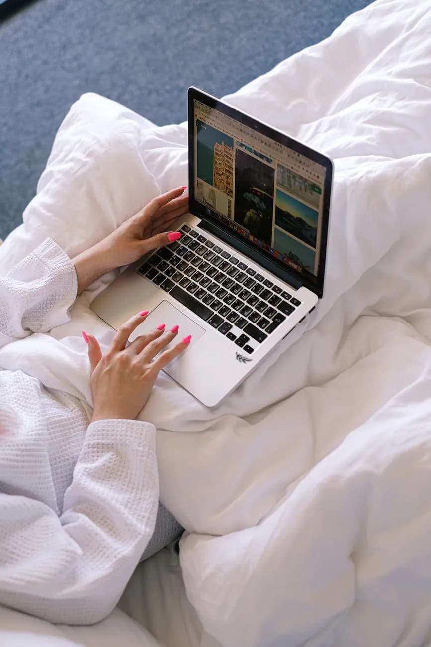 Hands typing on a laptop while planning an event