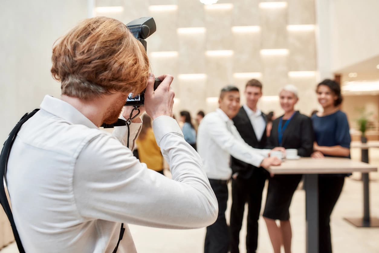 Event photographer capturing a group at a celebration